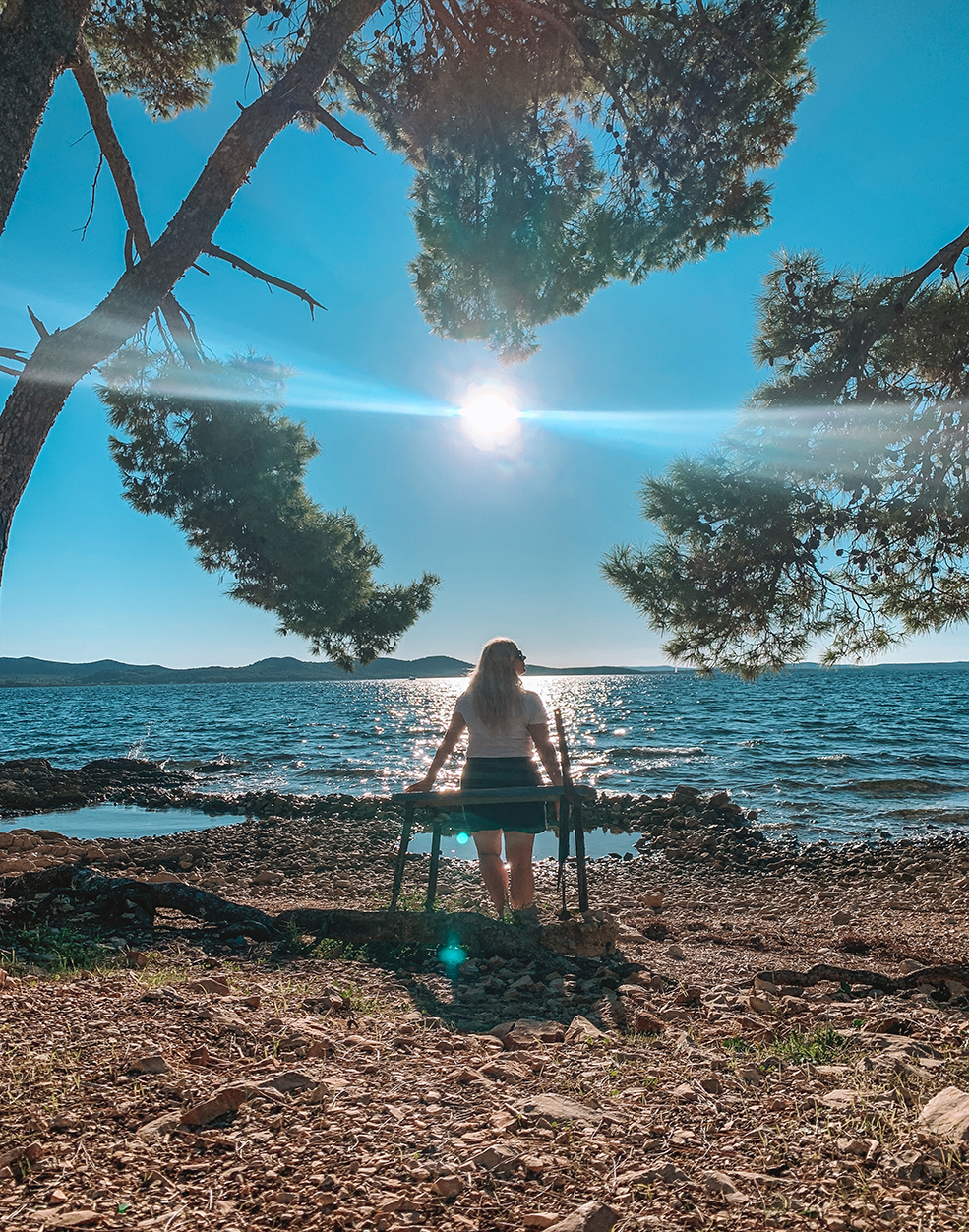 Woman sitting on a bench during sunset in Zadar Croatia beach